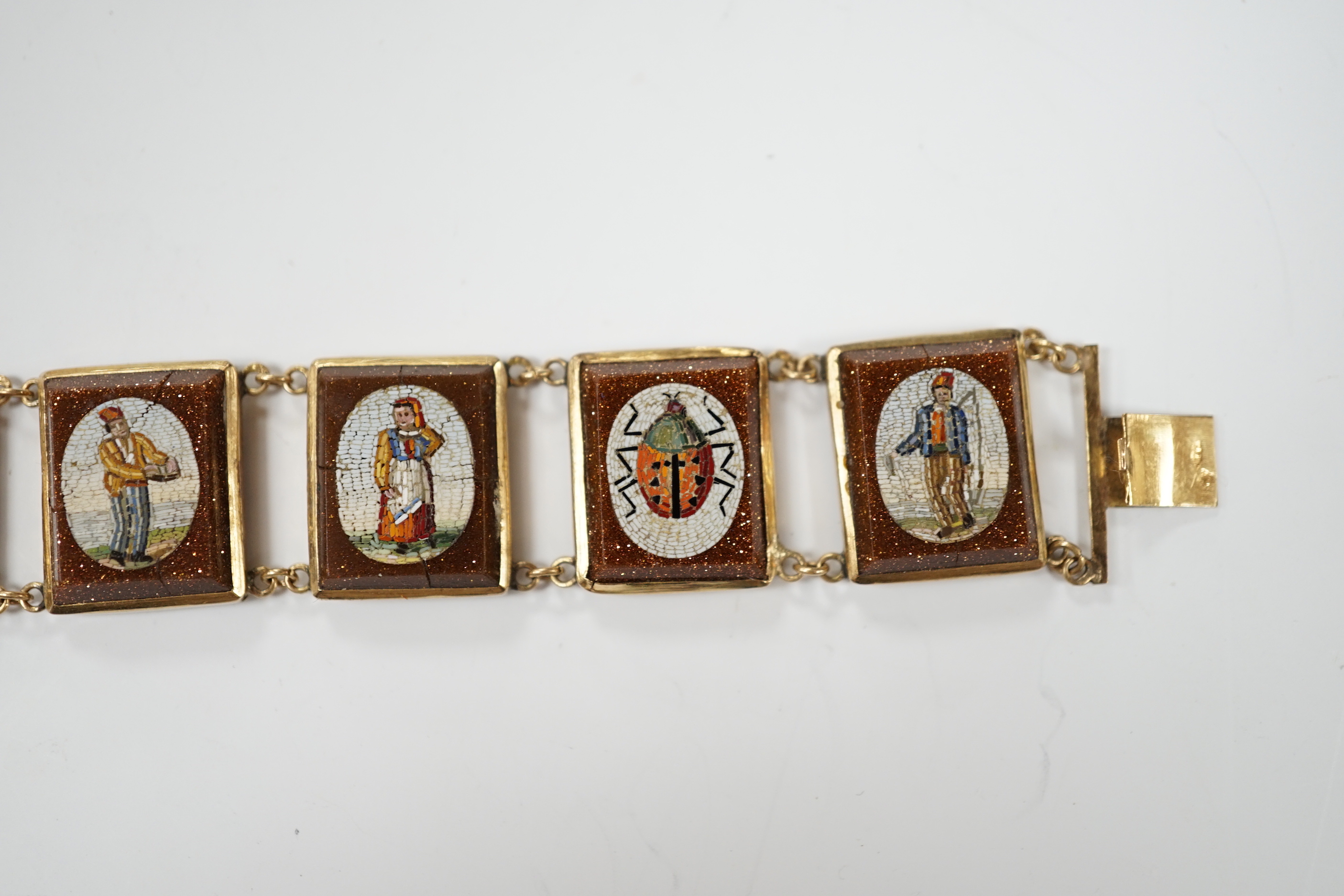 An Italian yellow metal, micro mosaic and goldstone set bracelet, with panels of Italian figures and insects, 17.3cm, gross weight 15.6 grams